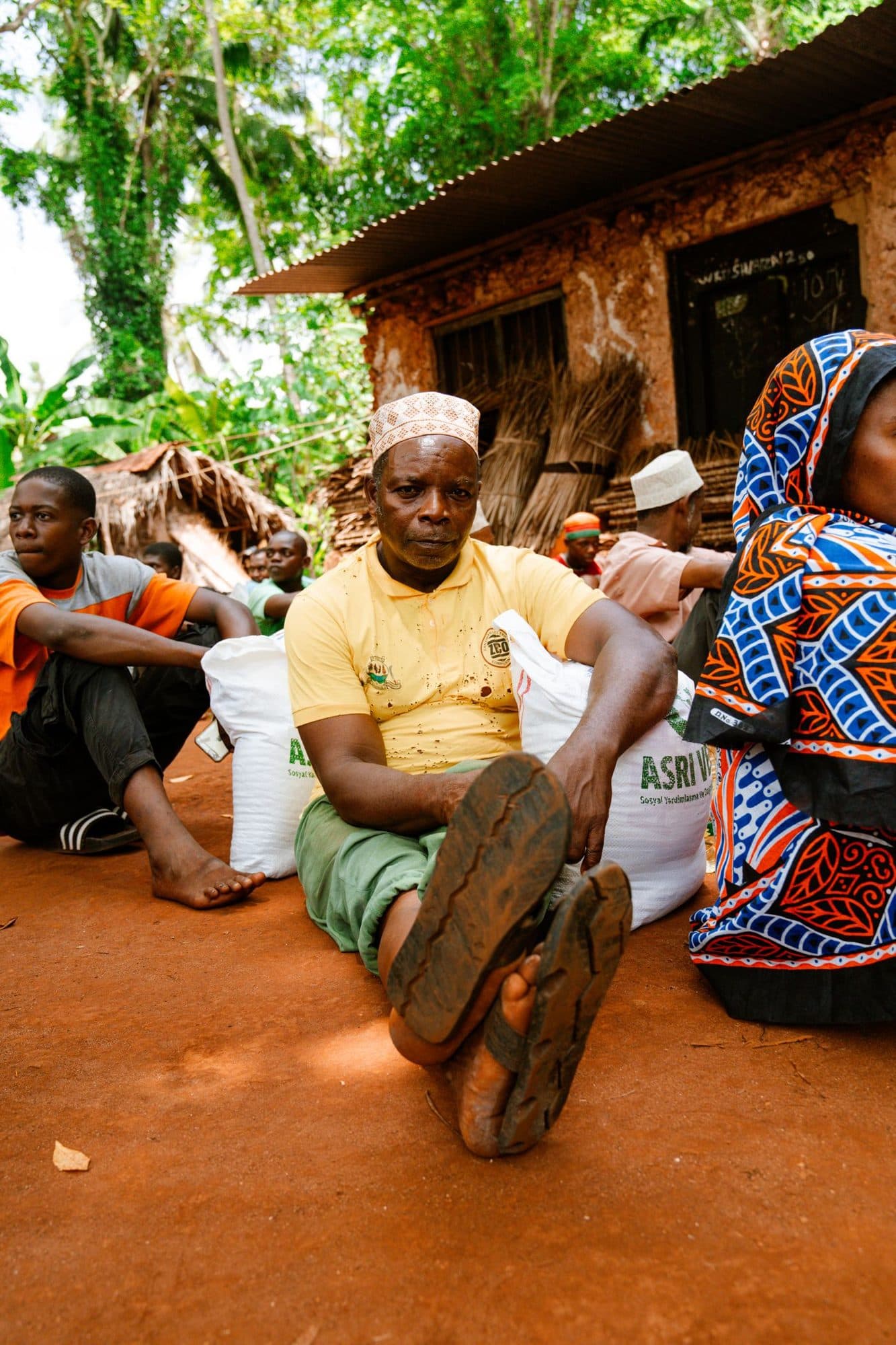 Community members seated together outdoors during a dialogue session