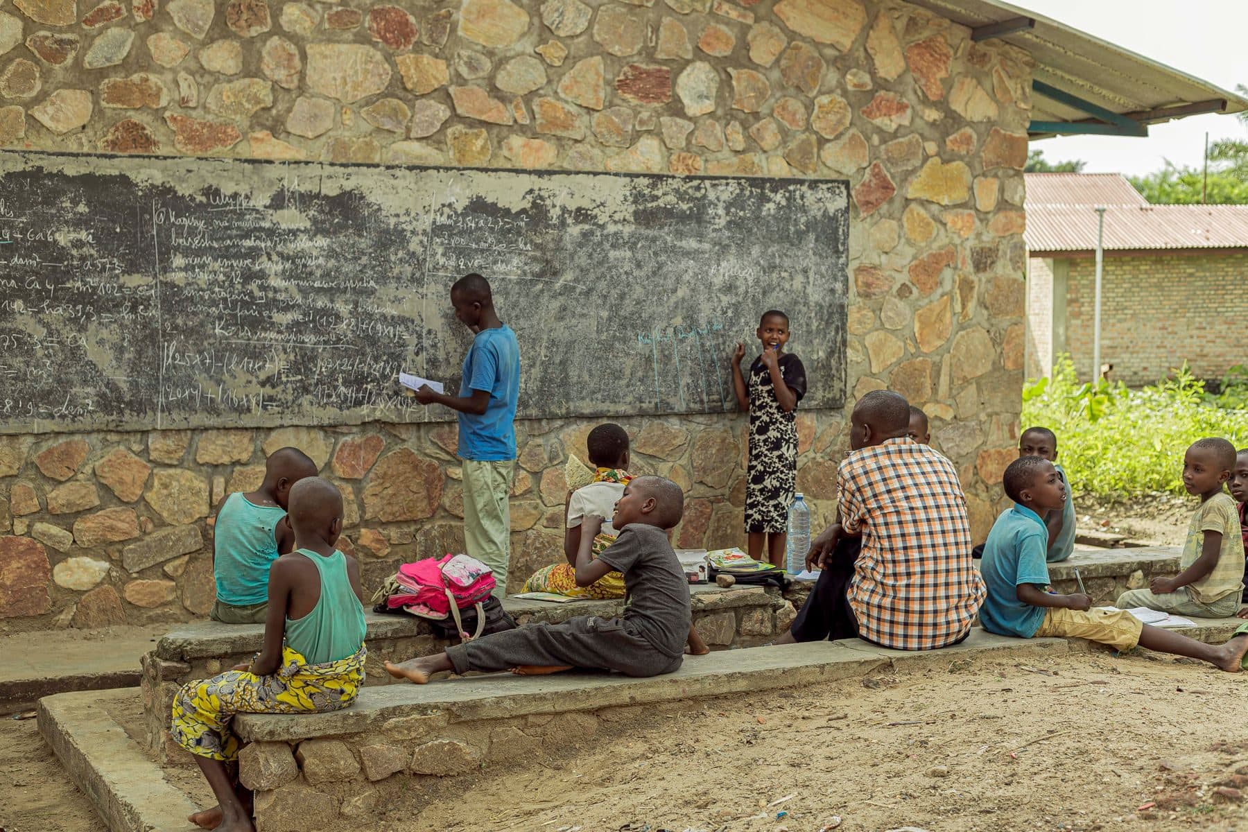 Learners and community members gathered for an outdoor lesson