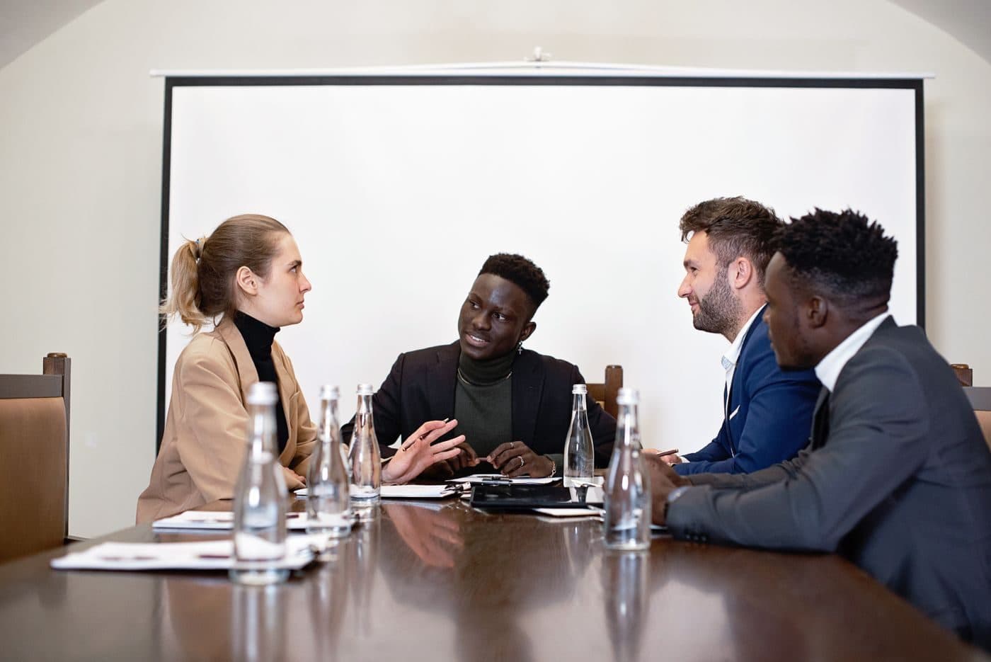 Colleagues in a workplace meeting around a boardroom table